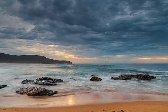 Sunrise at the seaside with rocks and beautiful diffused light b