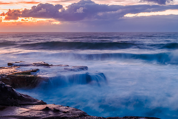 Sunrise, sea, waves, clouds and tessellated rock platform