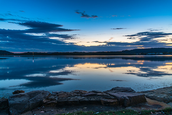 Sunrise waterscape with cloud reflections