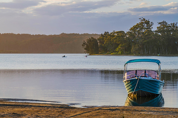 Sunset over the lake with boat on the shore