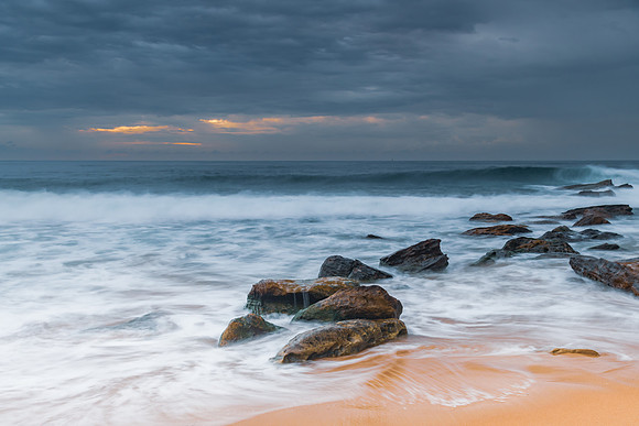 Sunrise at the seaside with rocks and beautiful diffused light b