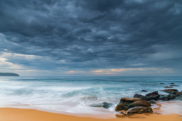 Sunrise at the seaside with rocks and beautiful diffused light b