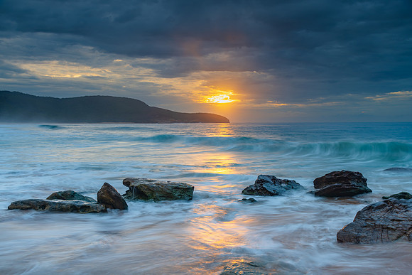 Sunrise at the seaside with rocks and beautiful diffused light b