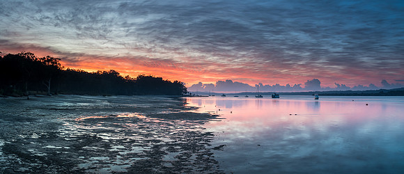 Sunrise Waterscape Panorama with High Cloud, Boats and Reflectio