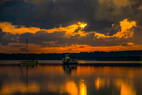 Red Moon behind the Storm Clouds with Boats on the Water