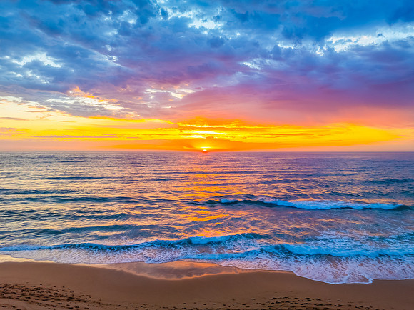 Pretty Sunrise at the seaside with rain clouds