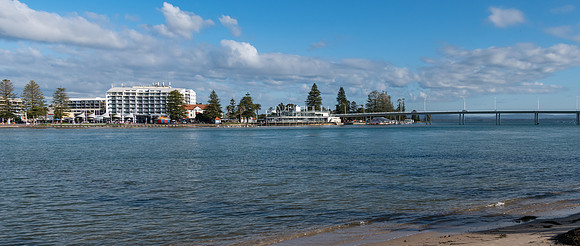 Panoramic waterside view of the lagoon with bridge and buildings