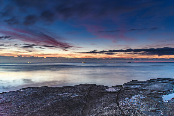Sunrise Seascape with Clouds and Ships on the Horizon