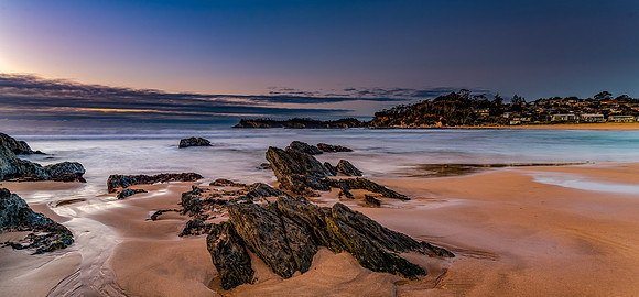 Sunrise seascape panorama at the beach with low cloud bank