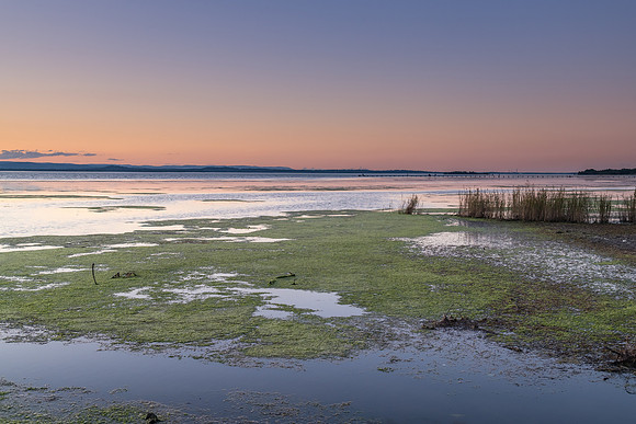 Sunset and soft shades pf pink and green over the Lake