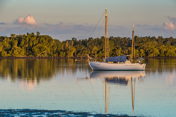 Sailing Boat with masks down on the Water and reflections