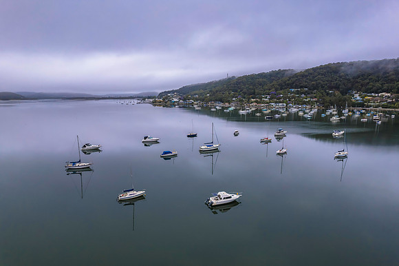 Cloud covered aerial waterscape with boats