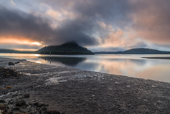 Misty and cloudy morning and low tide at the river with islands
