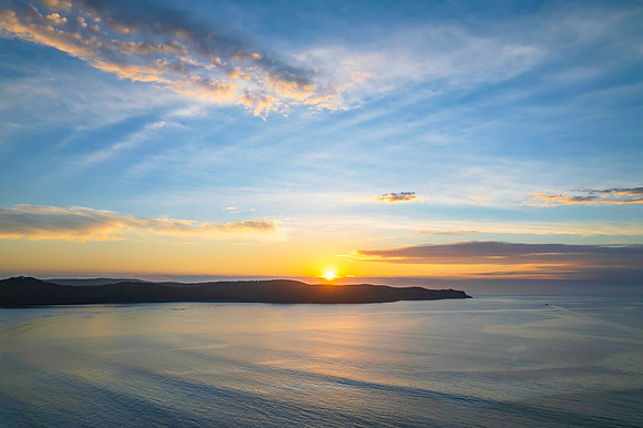 Sunrise seascape with a mix of high and medium clouds