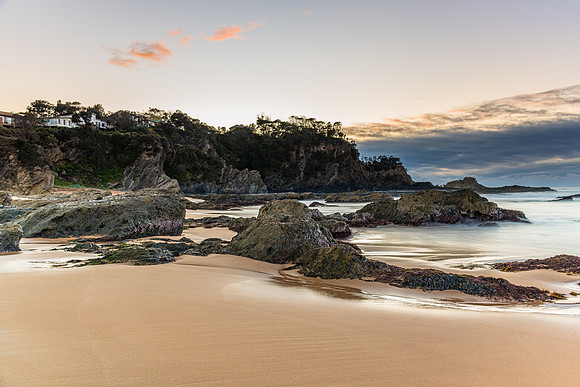 Sunrise at the beach with rocks and low cloud bank