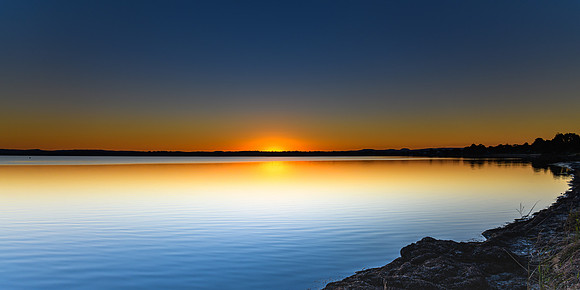 Sunset Panorama over the Lake with Clear Skies