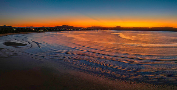 Aerial sunrise seascape with orange glow on a cold Winter's morn