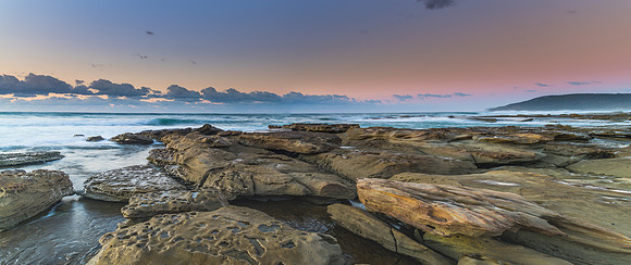 Sunrise seascape panorama with rock platform