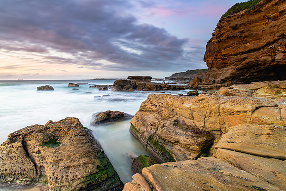 Sunrise Seascape with Clouds and Rocky Headland