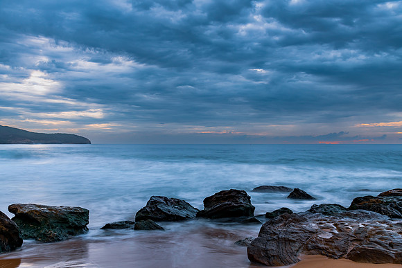 Sunrise at the seaside with rocks and beautiful diffused light b