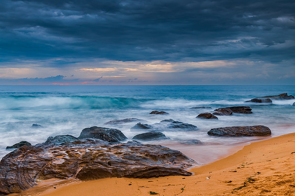 Sunrise at the seaside with rocks and beautiful diffused light b