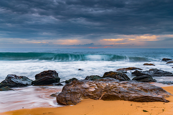 Sunrise at the seaside with rocks and beautiful diffused light b