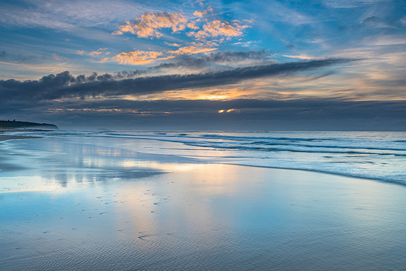 Sunrise Seascape with Clouds and Ships on the Horizon