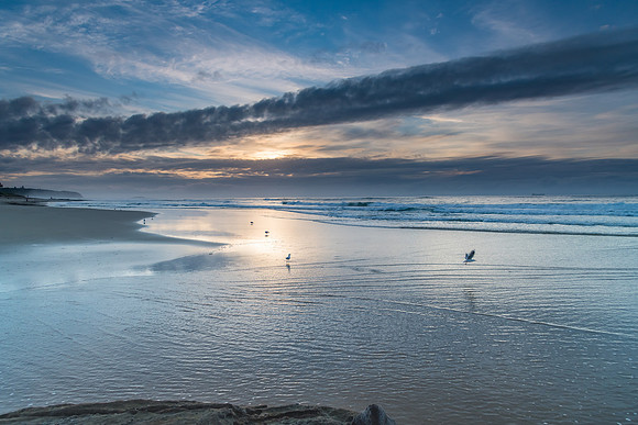 Sunrise Seascape with Clouds and Reflections