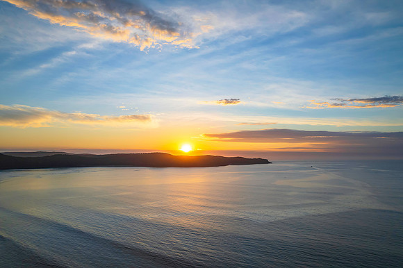 Sunrise seascape with a mix of high and medium clouds