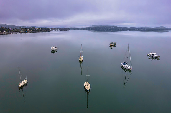 Cloud covered aerial waterscape with boats