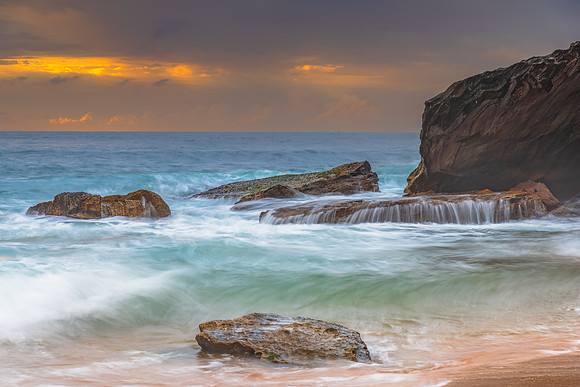Sunrise at the seaside with rocks and beautiful diffused light b