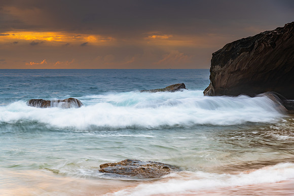 Sunrise at the seaside with rocks and beautiful diffused light b