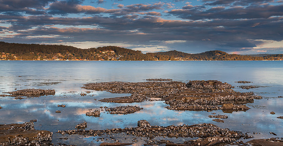 Clouds, reflections and a panorama sunset waterscape