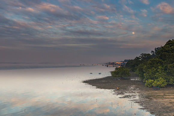 Sunrise Waterscape with Reflections and Moon