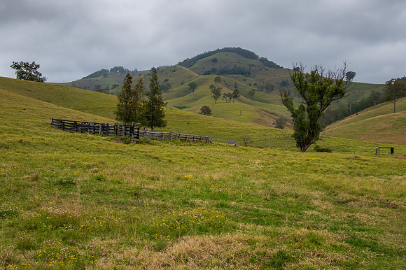 Overcast day in the country surrounded by rural land and hills