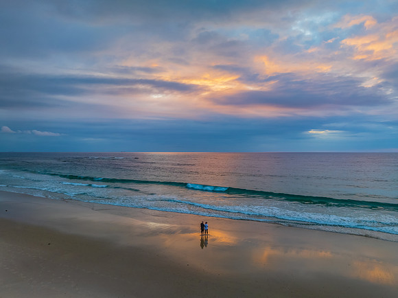 Sunrise Seascape with beautiful cloud covered sky and gentle sur
