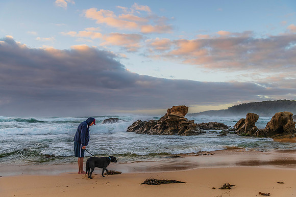 Rocks, waves, man and dog - sunrise seascape at Bermagui