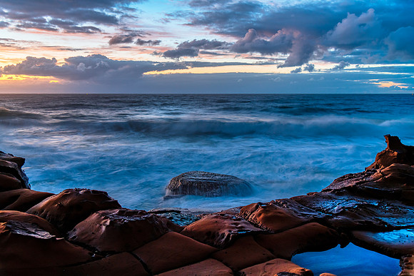 Sunrise, sea, waves, clouds and tessellated rock platform
