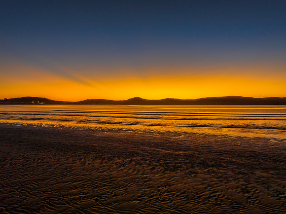 Aerial sunrise seascape with orange glow on a cold Winter's morn