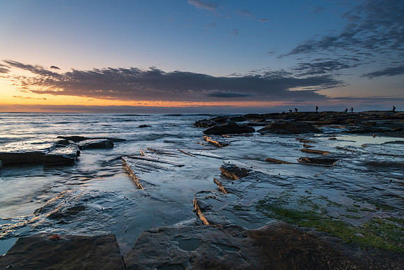 Rocky sunrise seascape - how many photographers can fit on one r