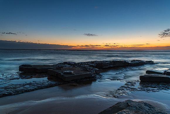 Rocky coastline sunrise seascape