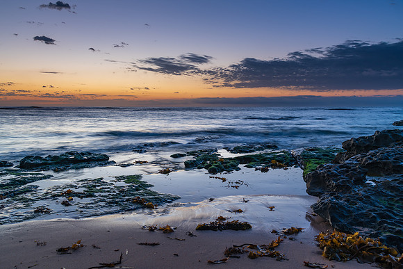 Rocky coastline sunrise seascape