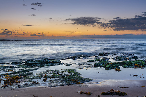 Rocky coastline sunrise seascape