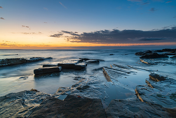 Rocky coastline sunrise seascape