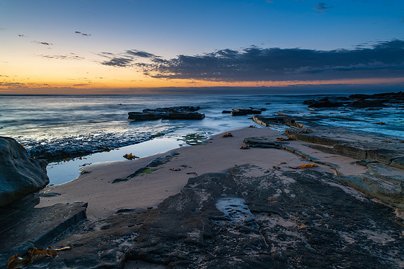 Rocky coastline sunrise seascape