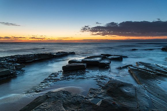 Rocky coastline sunrise seascape