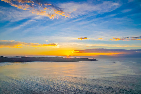 Sunrise seascape with a mix of high and medium clouds