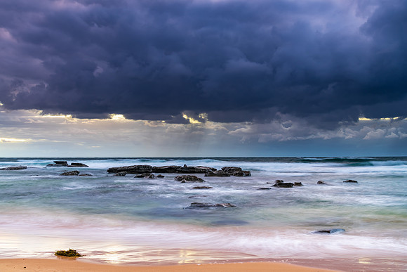 Moody morning bay seascape with rain clouds
