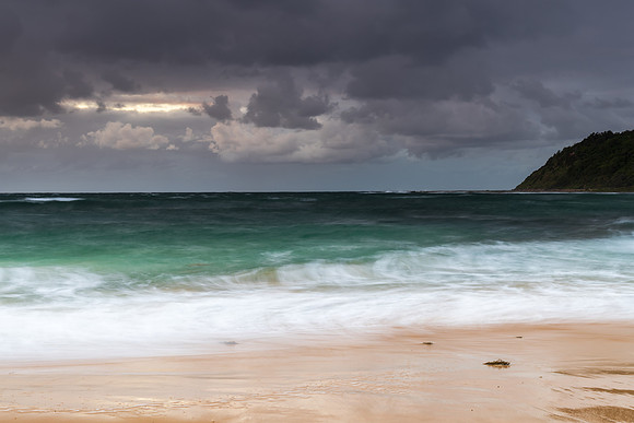 Moody morning bay seascape with rain clouds