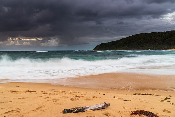 Moody morning bay seascape with rain clouds